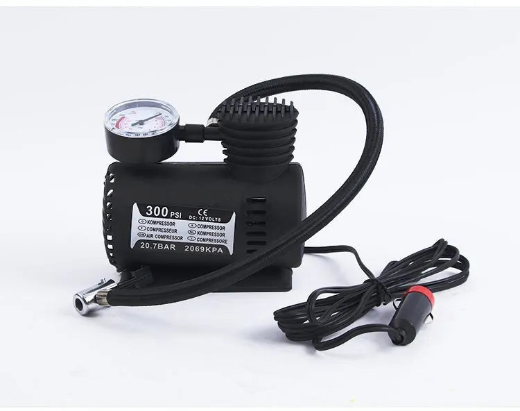 Black 12V portable mini air compressor with 300 psi gauge, 9-foot cord, and two adapter nozzles on a neutral background