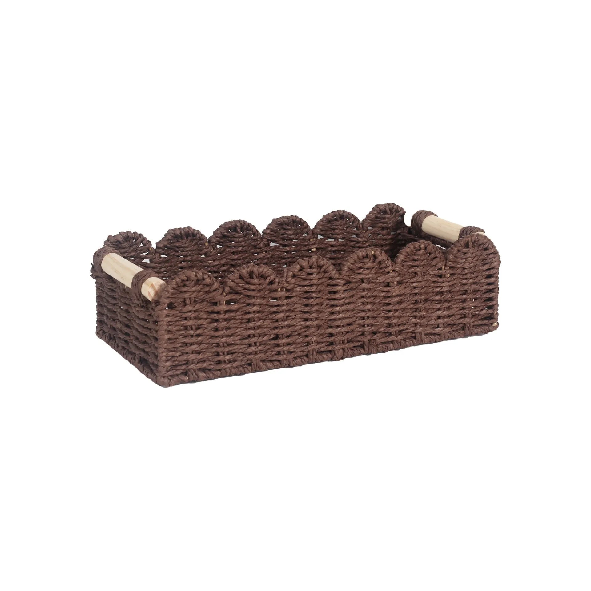 Modern woven rectangular storage basket in khaki colour on a wooden table holding remote controls and pens.