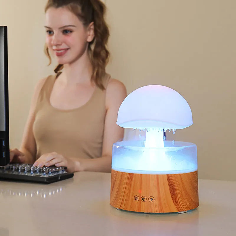 White rain cloud-shaped humidifier and essential oil diffuser on a surface
