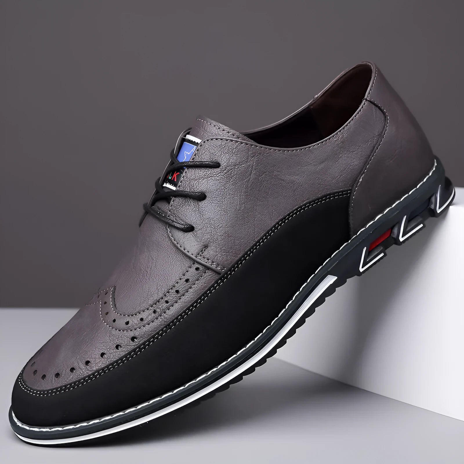 Men's casual leather shoes in black with a fabric upper, leather toe cap, rubber sole, and decorative stitching.