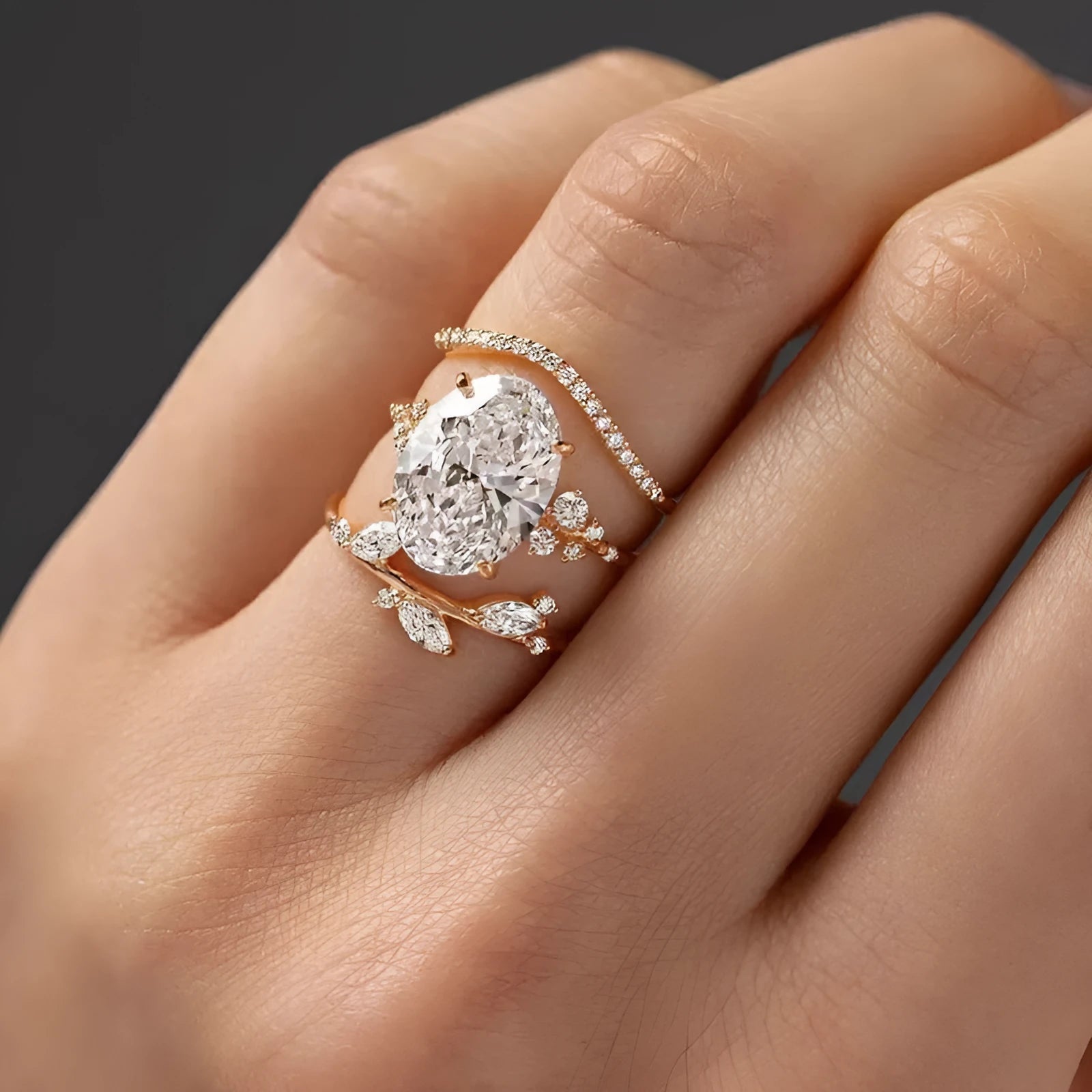 Three copper alloy rings with goose egg-shaped cut zircon stones in Q681 gold finish, flower and geometric designs, sizes 6 to 10