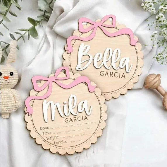Square wooden baby room ornament with space for a customised name, shown in two size options.