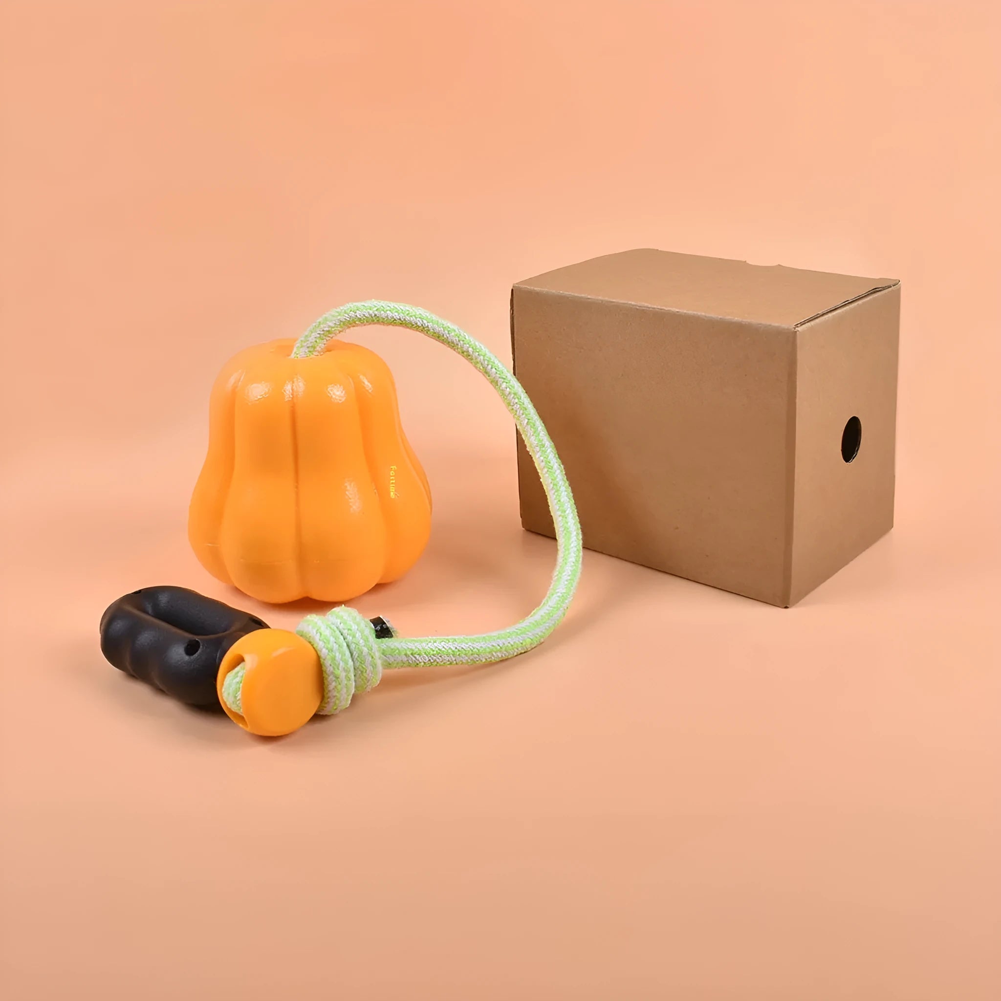 Pumpkin orange plastic dog toy with rope handle and molar-textured chewing surface