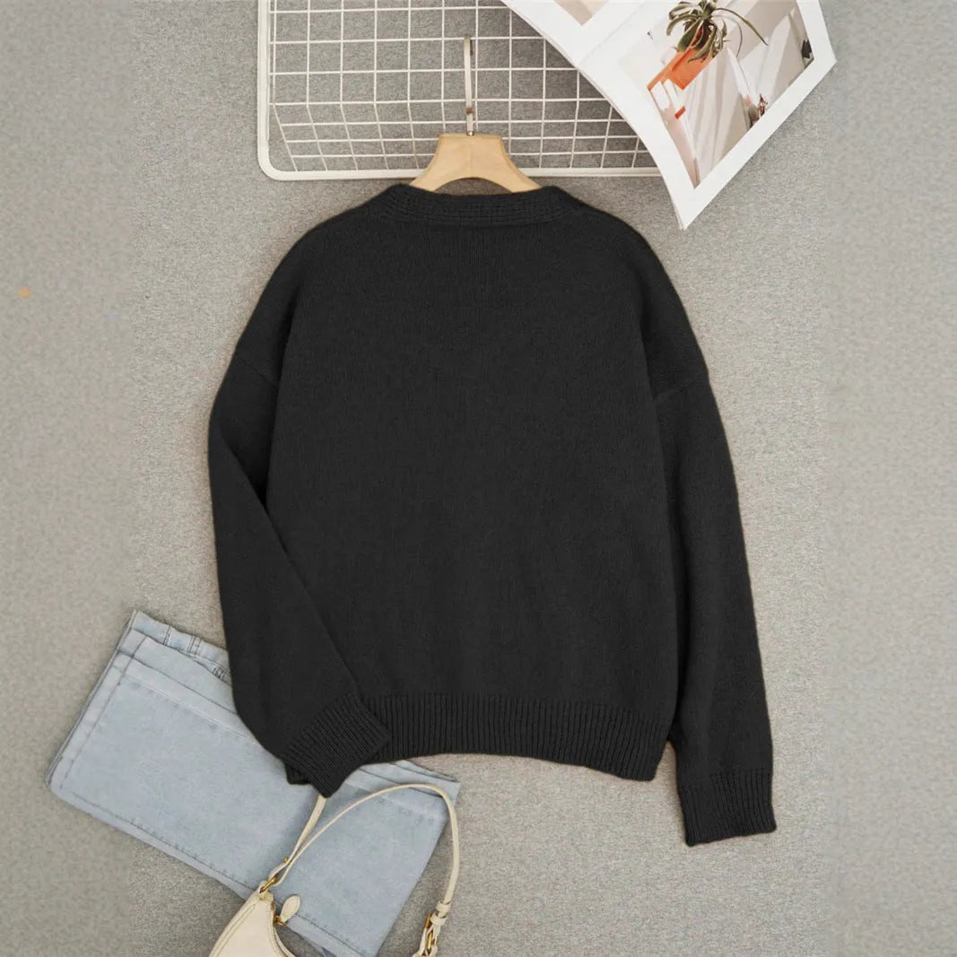 Loose fit animal pattern knitted cardigan sweater in black, made from polyester, with conventional sleeves.