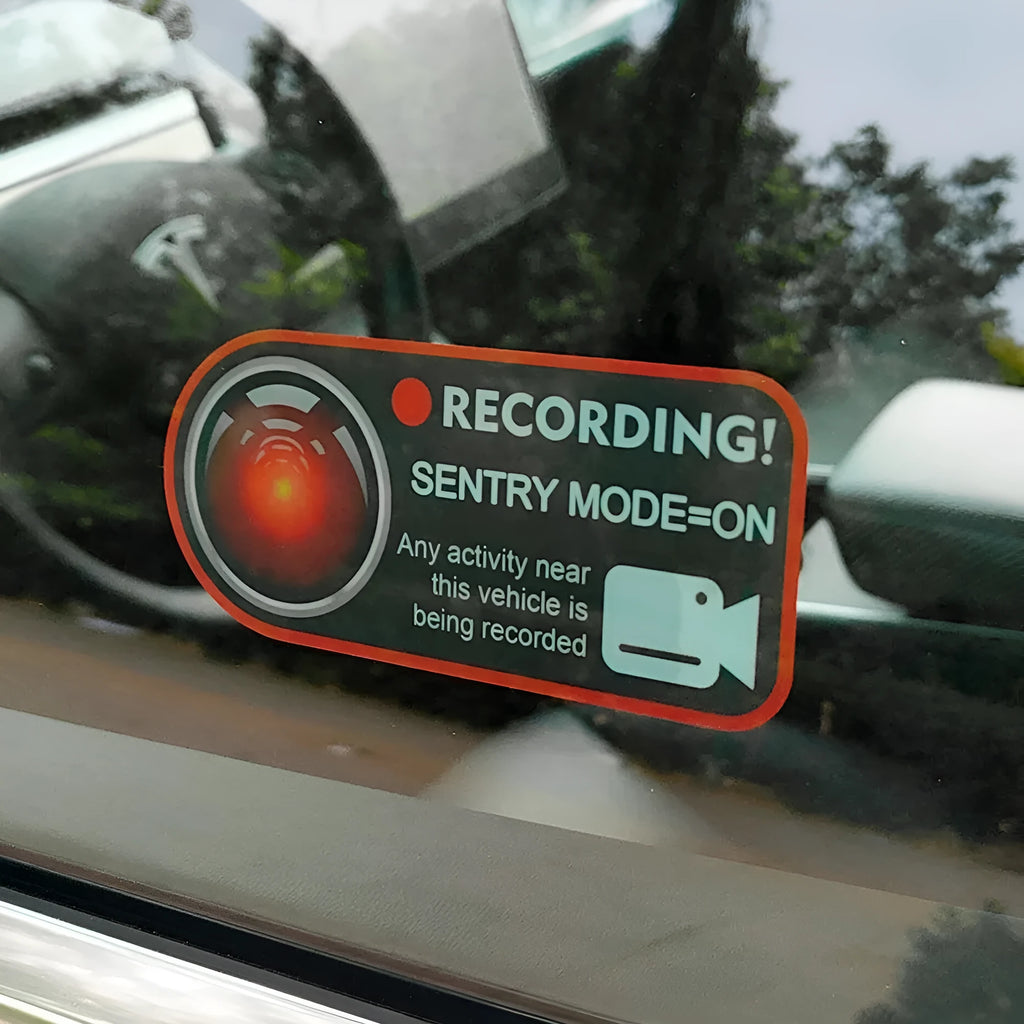 Pair of white electrostatic warning stickers for Tesla Sentry Mode on a car window.