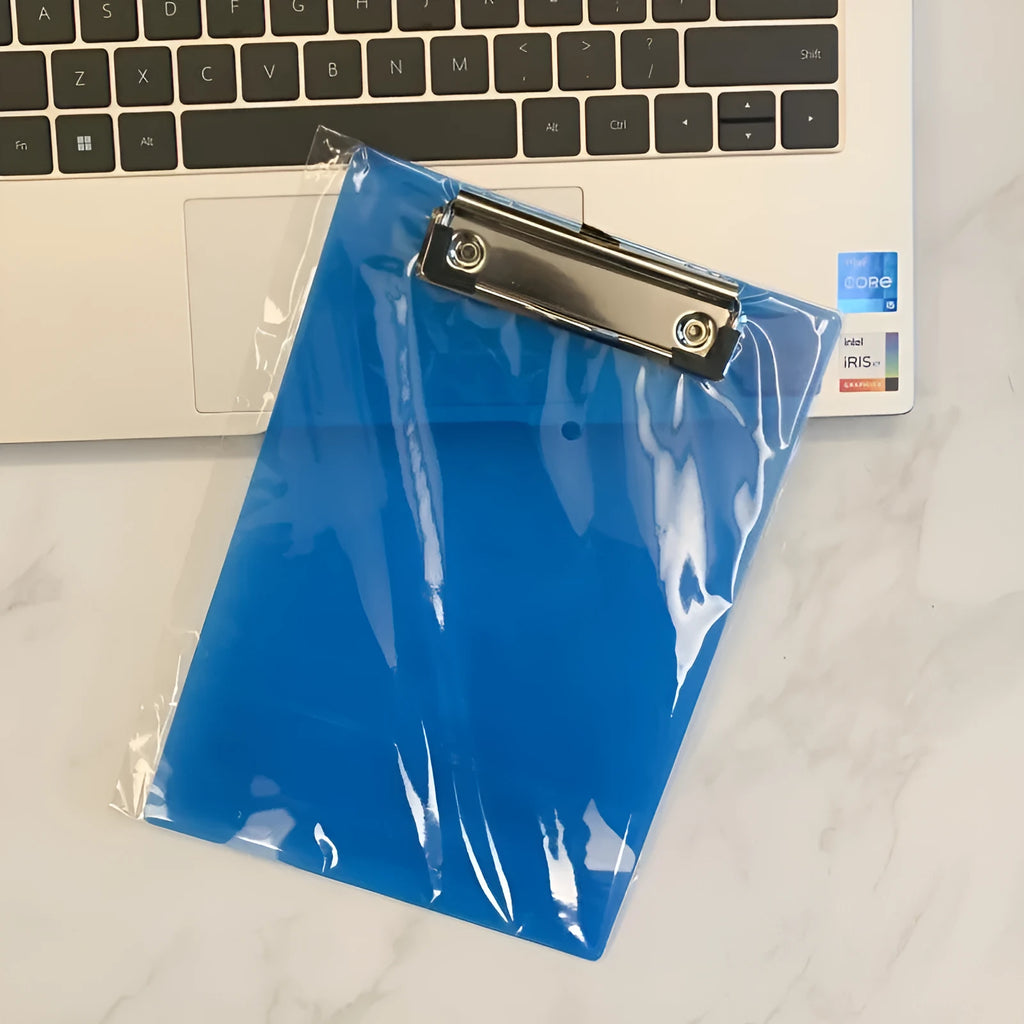 A4 transparent plate clipboard with metal clip, shown in blue colour on a desk with paper.