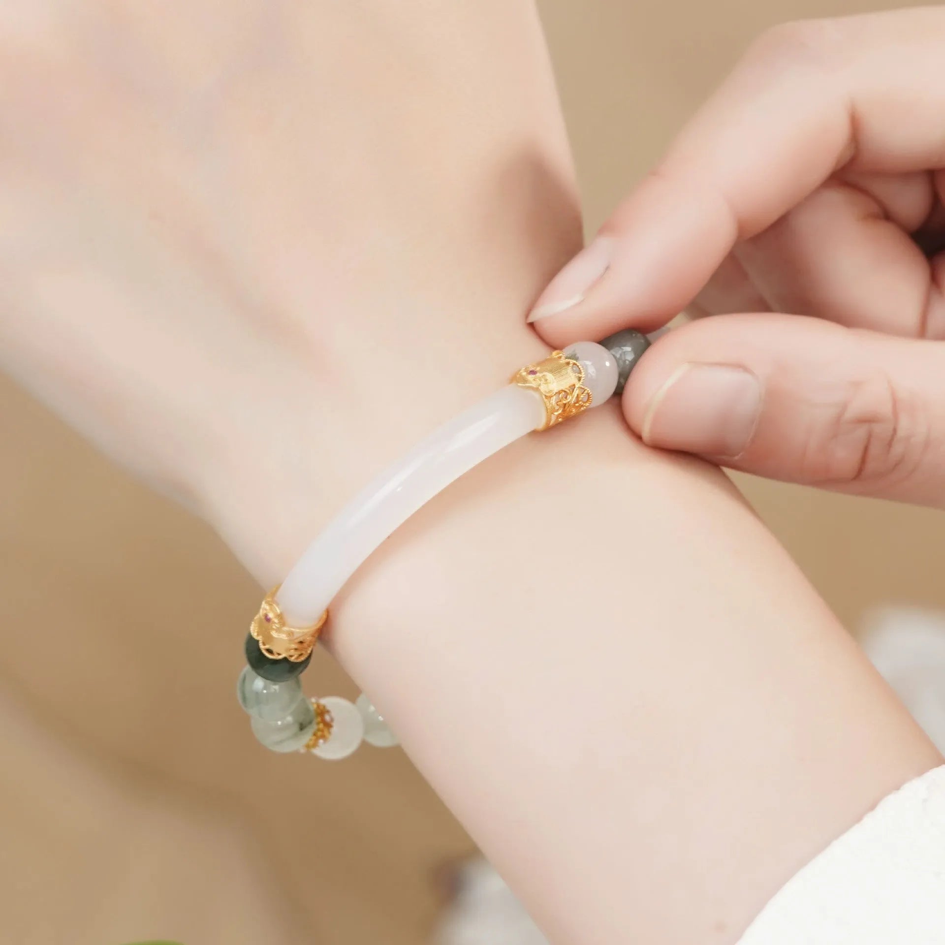 Emerald green jade bangle bracelet with floating flower design and round beads