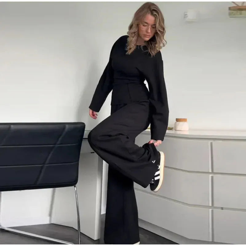 Women's black polar fleece suit set with long sleeve top and wide leg trousers
