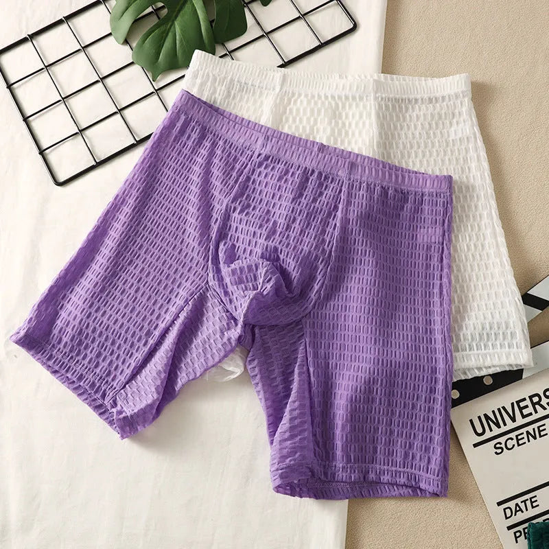 Men's solid colour lace boxer underwear with hip lifting design on a mannequin.