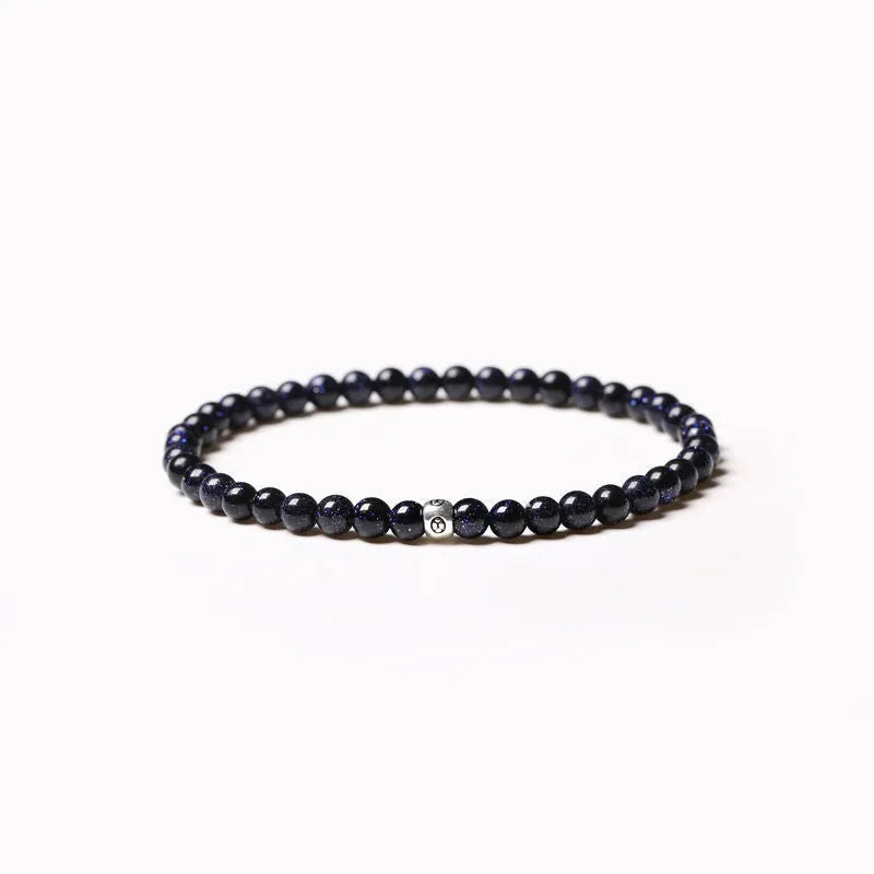 Unisex bracelet with black obsidian, blue San, and agate beads in round and square geometric shapes.