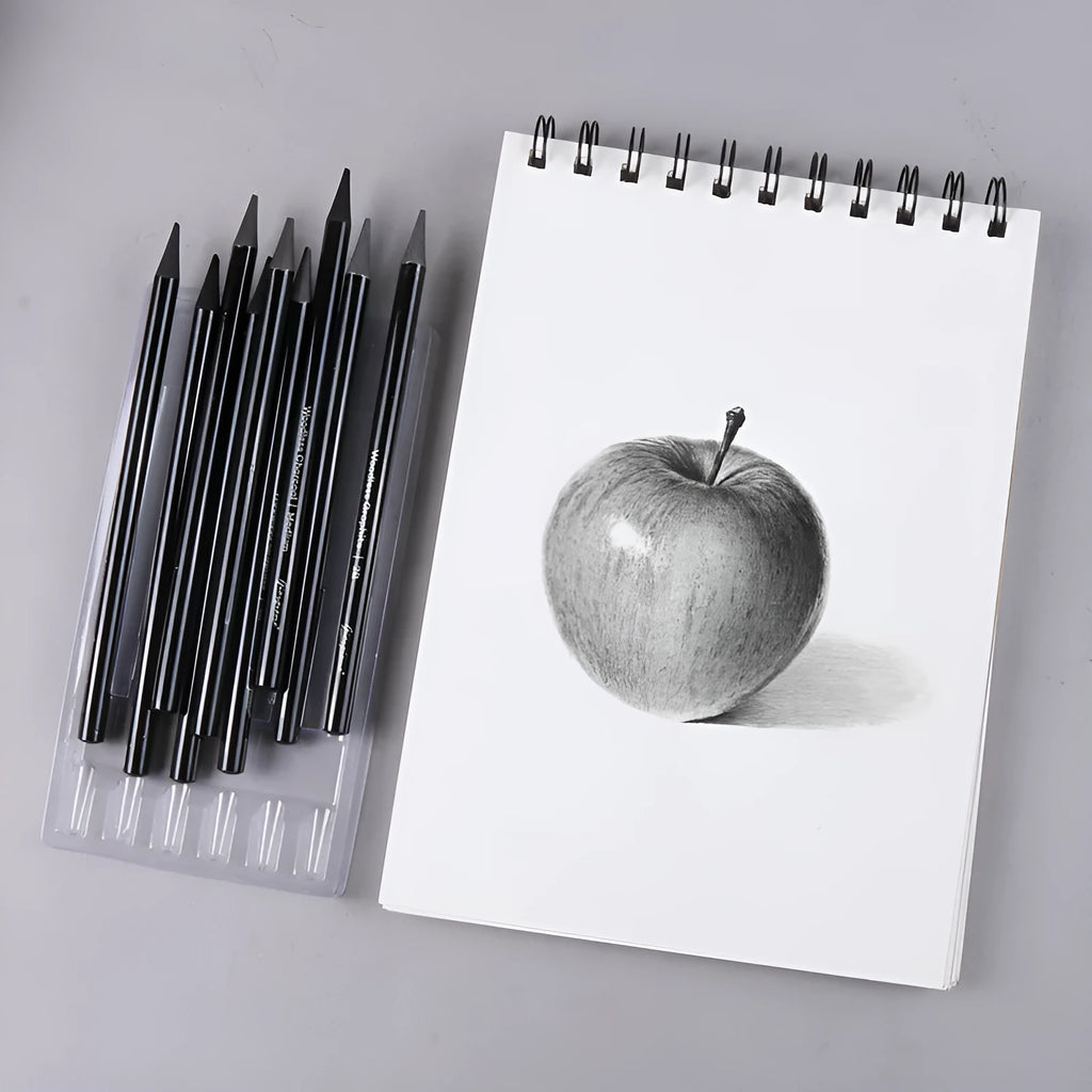 Set of six graphite pencils and three carbonized drawing pencils with wooden casings on a blister card.