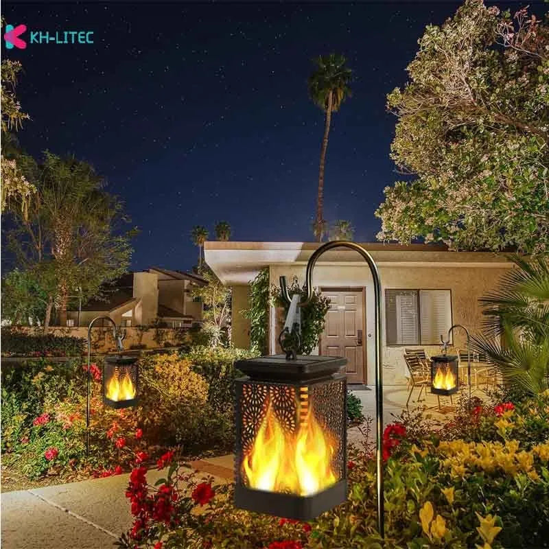 Set of four black solar-powered hanging lanterns with flickering flame LED lights for outdoor garden decoration.