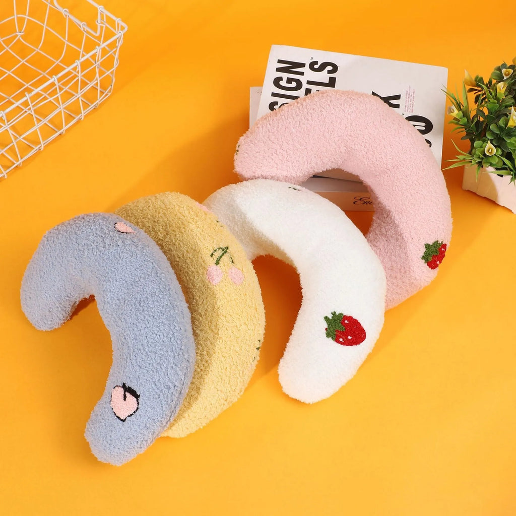 Half moon U-shaped cloth pillow for cats in blue, pink, white, and yellow colour options.