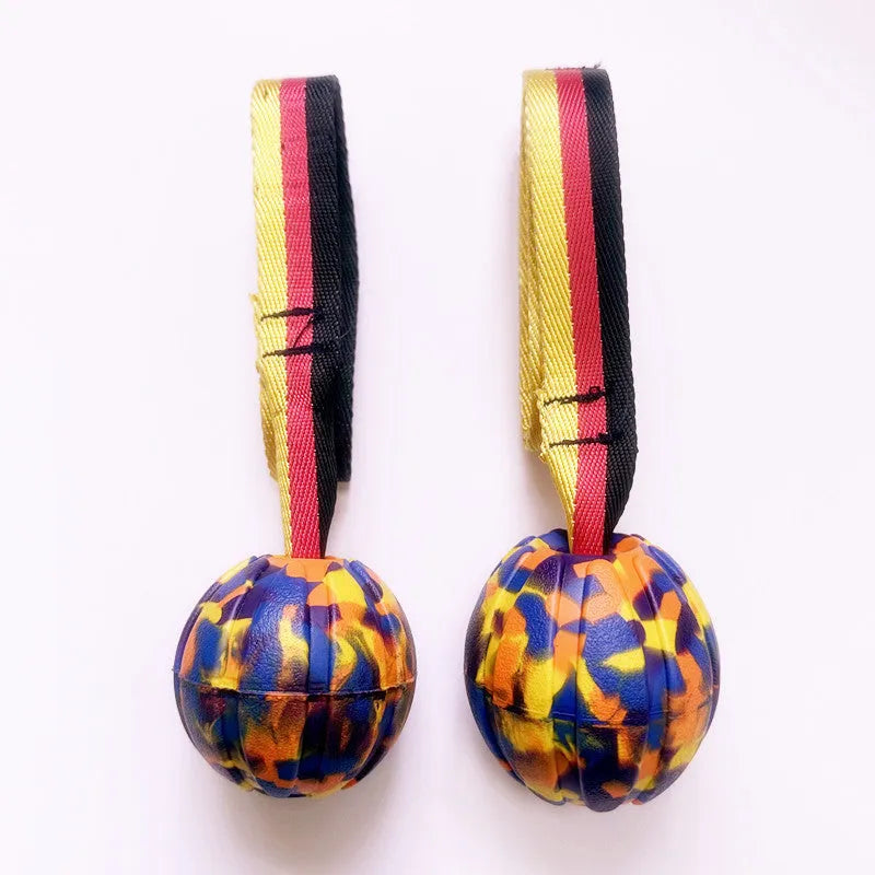 Yellow and camouflage coloured EVA floating dog balls with strings in 6.5cm, 7cm, and 9cm sizes.