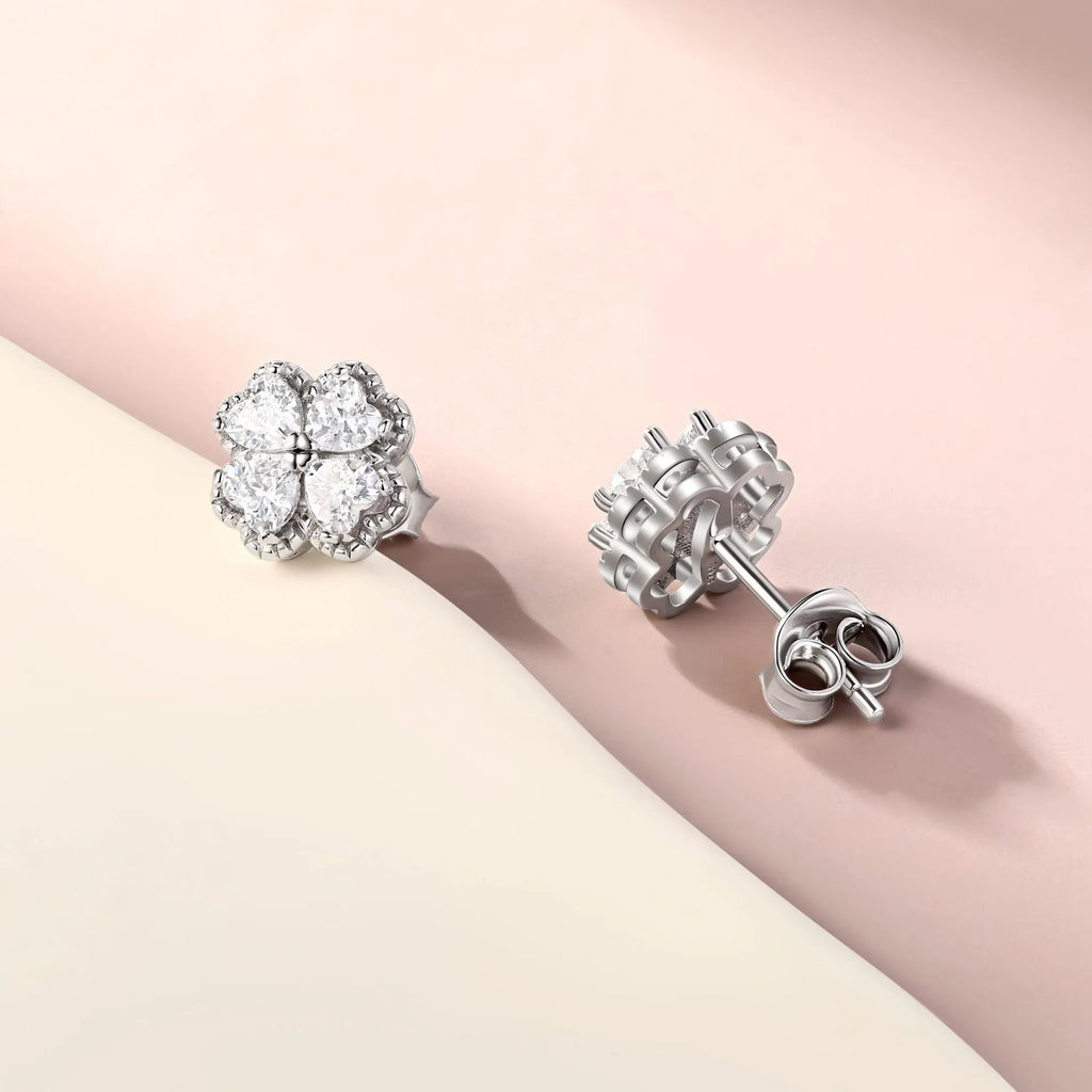 Pair of heart-shaped sterling silver earrings with four-leaf clover design and white gold colour finish.