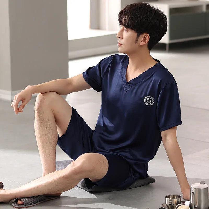 Man wearing a loose blue short-sleeved ice silk pyjama shirt and matching shorts.