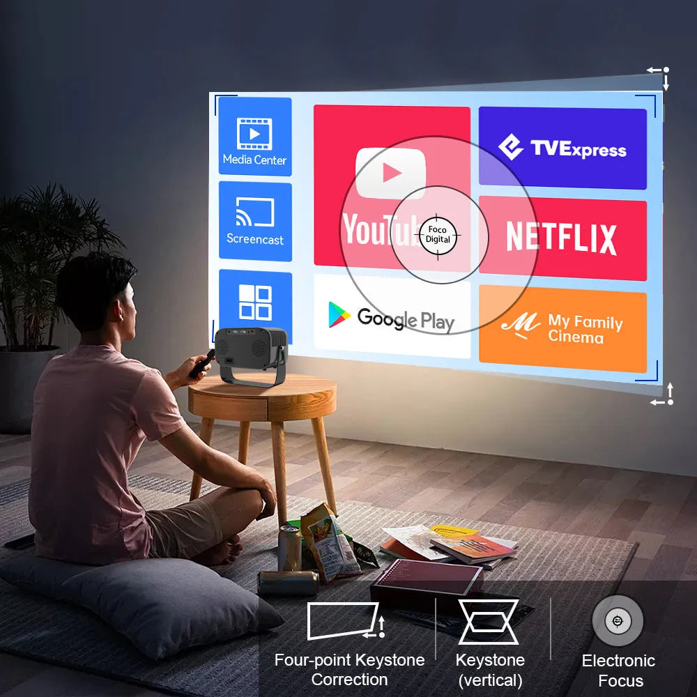 Black portable HD smart projector with remote control on table