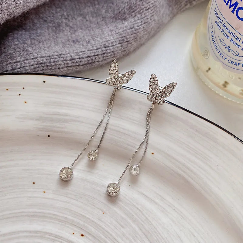 Silver alloy butterfly tassel earrings with geometric design, fresh style, on white background