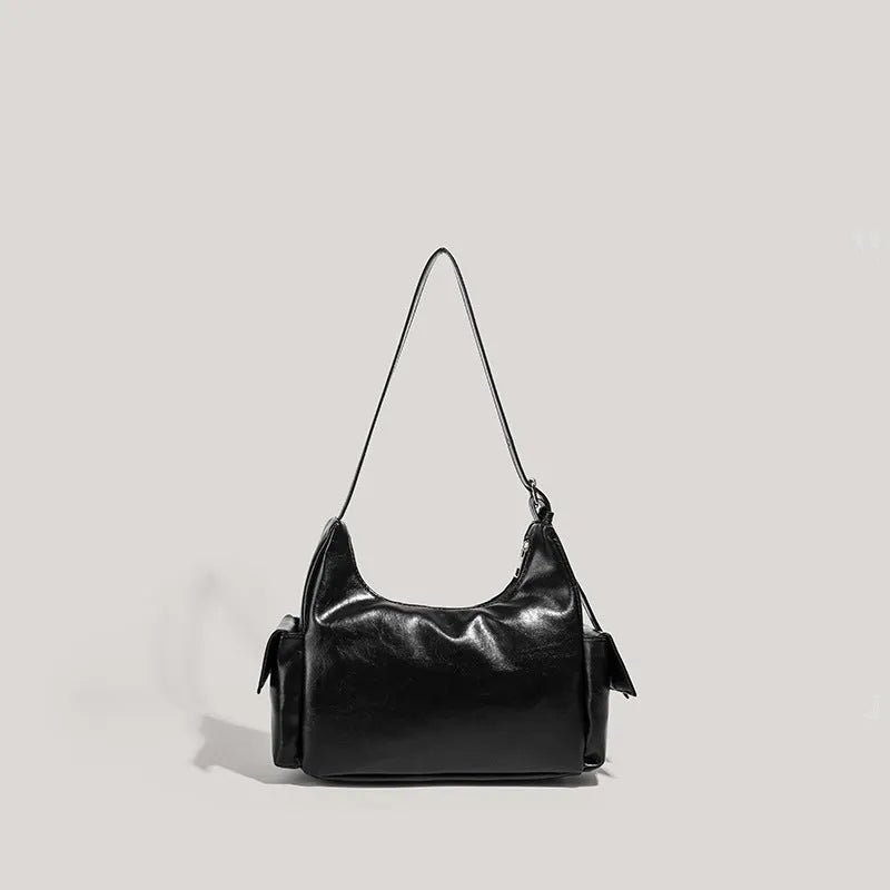 Black PU leather shoulder motorcycle bag with sewing line details against a plain background