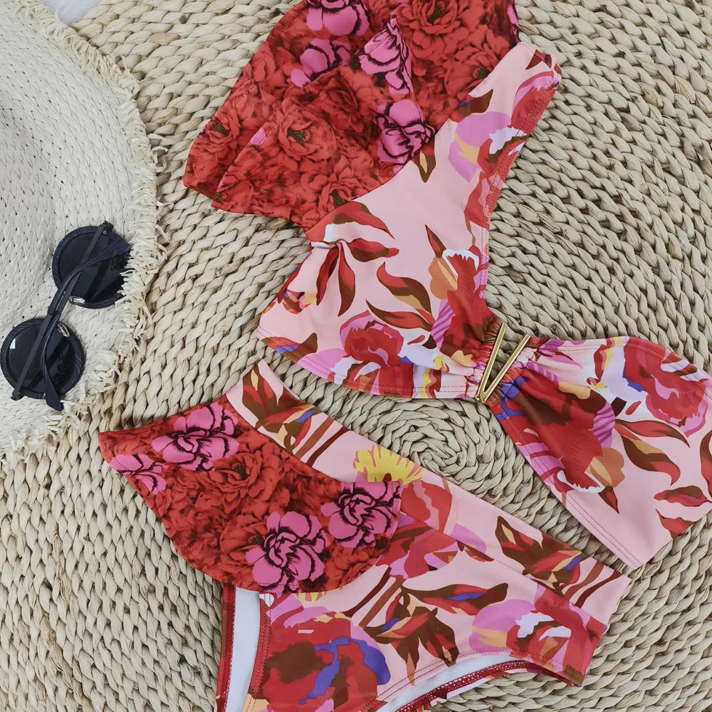 Women's pink one-shoulder ruffled swimsuit with red flower print and high-waisted briefs