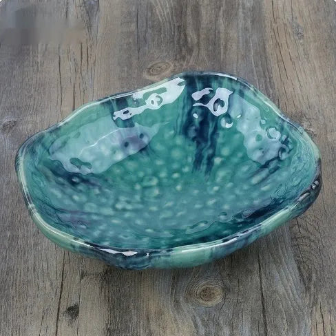 Irregular shaped Japanese coarse pottery bowl with floral decoration measuring 24cm length