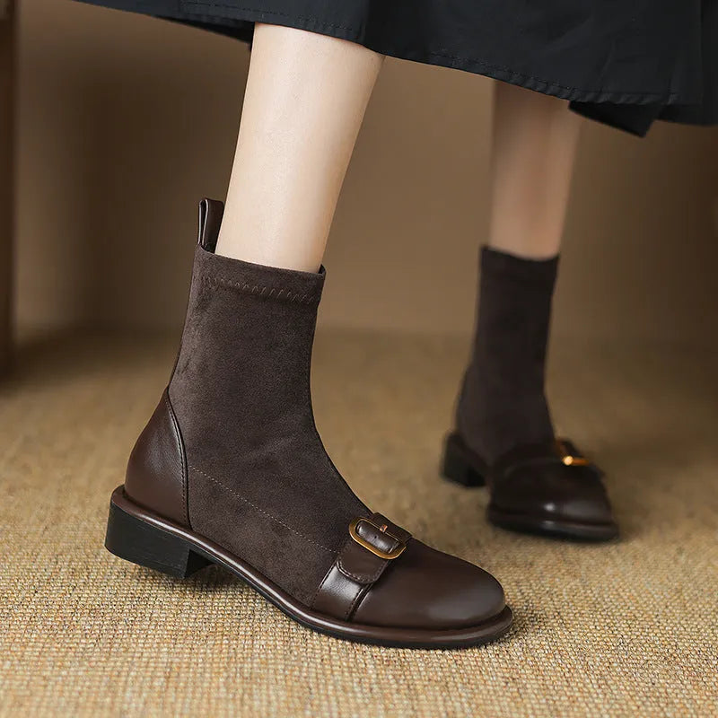 Women's black low-heel Martin ankle boots with buckle stitching and lace-up front.