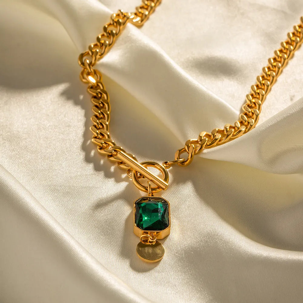 Gold geometric round zircon pendant necklace on a titanium steel Cuban link chain.