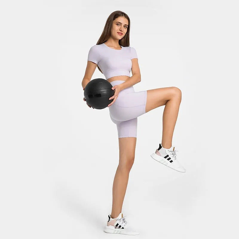 Women's solid colour sports shorts in a cotton blend fabric with super stretch, shown in a mid-length fit.