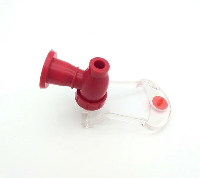 Red plastic Magic Tap soda dispenser screwed onto a 2-litre bottle with push-in tap