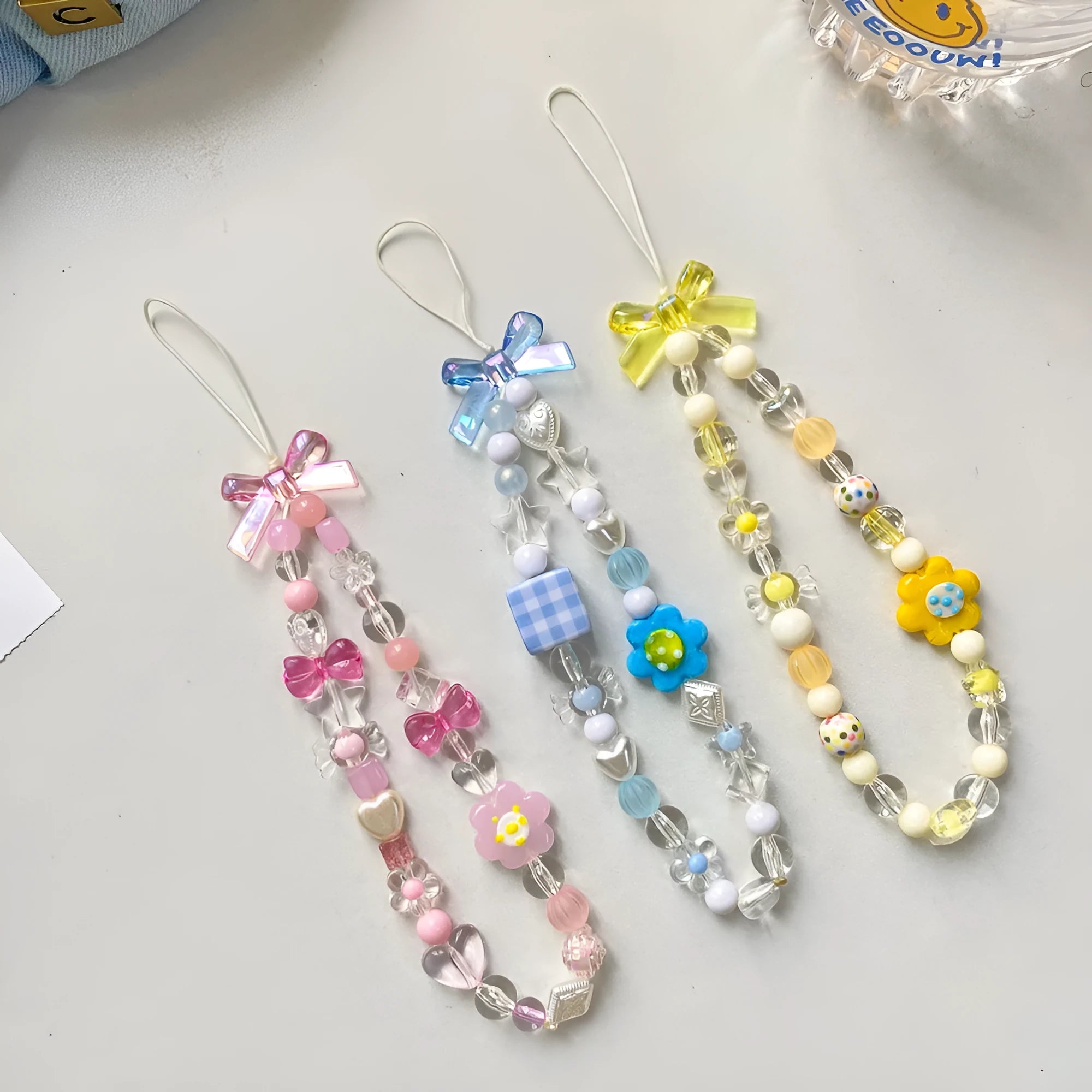 Colourful beaded flower mobile phone lanyard with hand rope design in blue, pink and yellow options