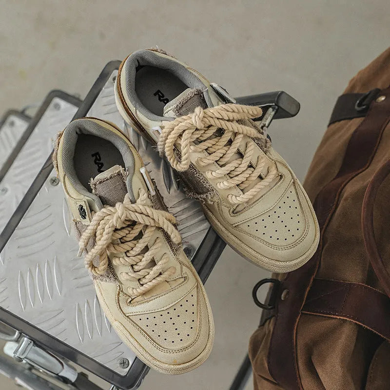 Beige vintage patch skateboard shoes with low-top design and round toe
