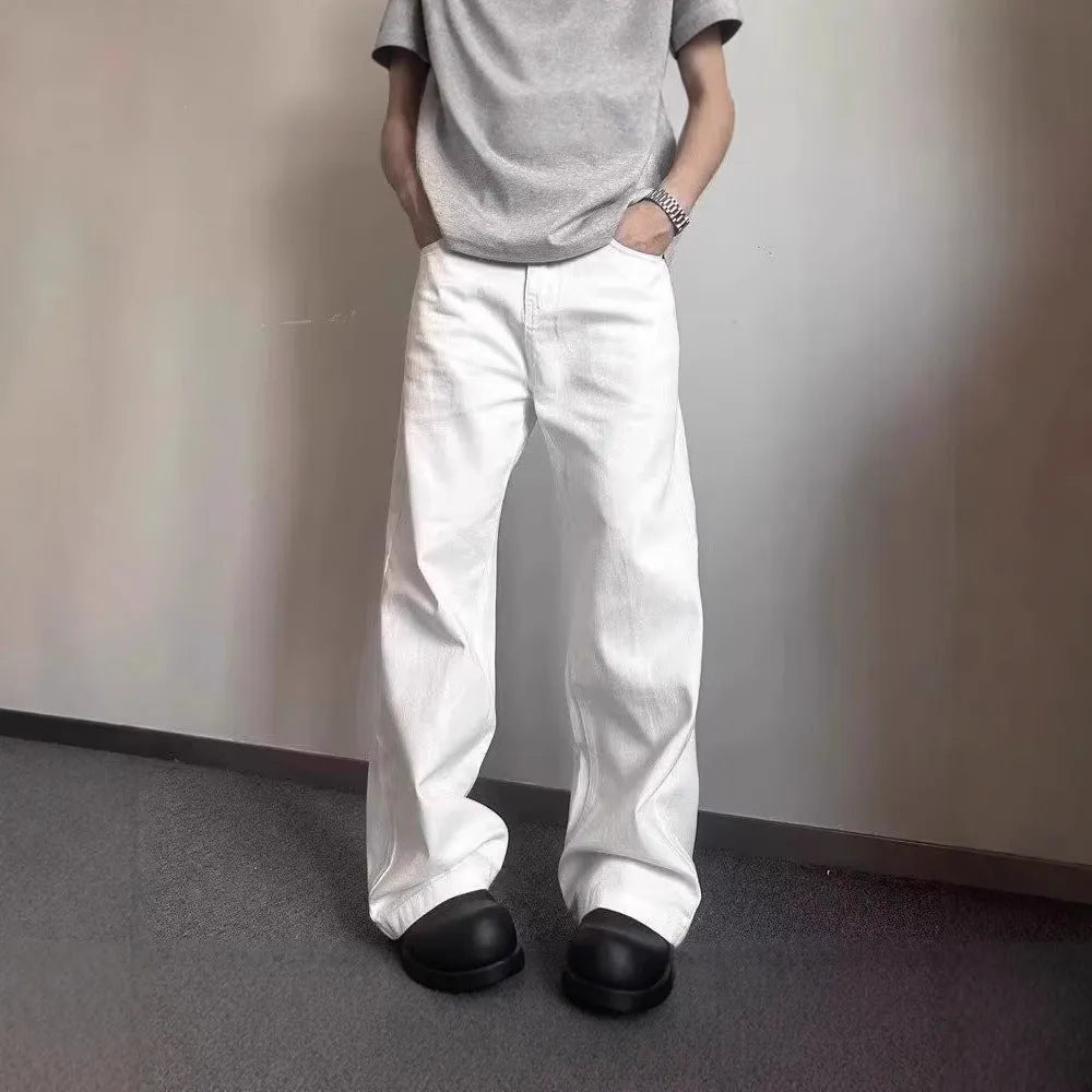 Men's white loose fit wide-leg straight denim jeans on a mid-waist model.