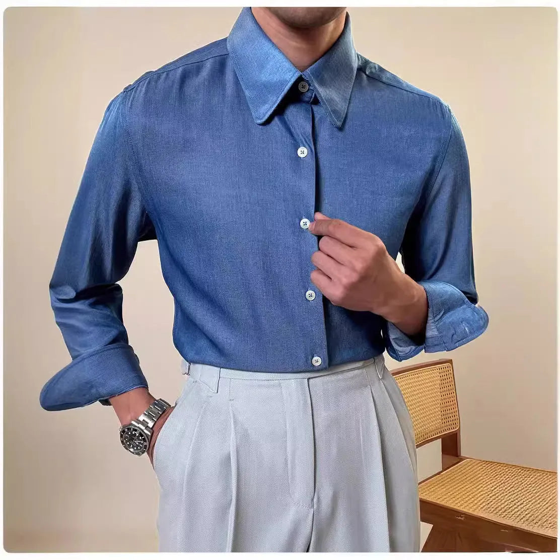 Man wearing a slim-fit light blue round collar long sleeve shirt for business casual wear.