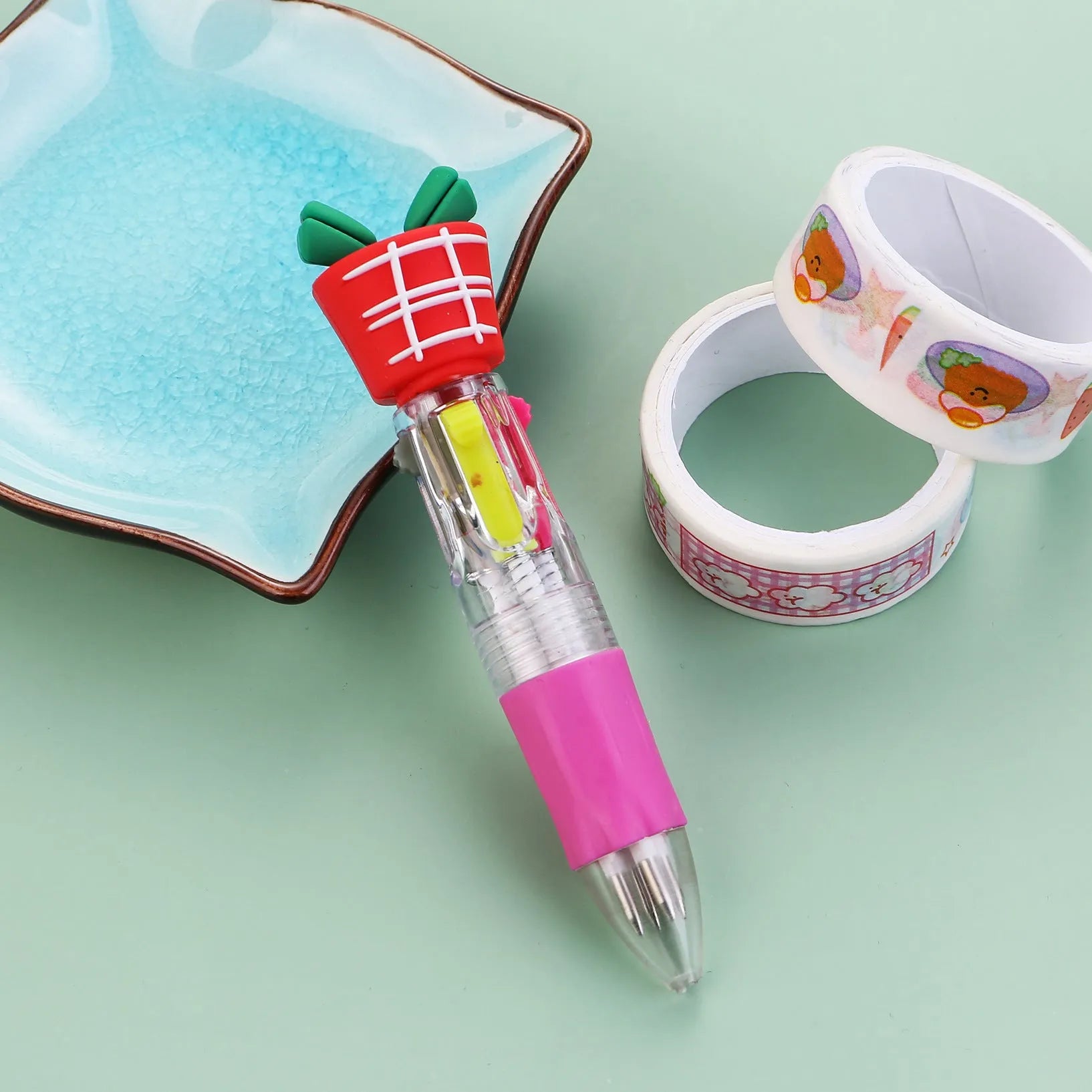 11cm long Christmas-themed four-colour ballpoint pen showing festive designs like reindeer and trees.
