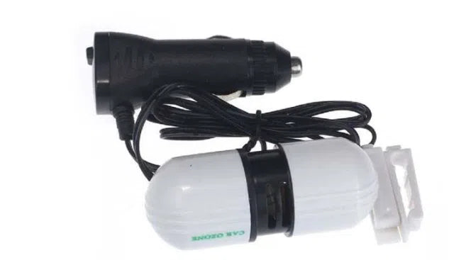 White car air purifier deodorizer 75x30x26mm with 12V plug on a surface
