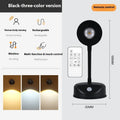 Geometric modern rechargeable wireless wall spotlight in black on a white wall.