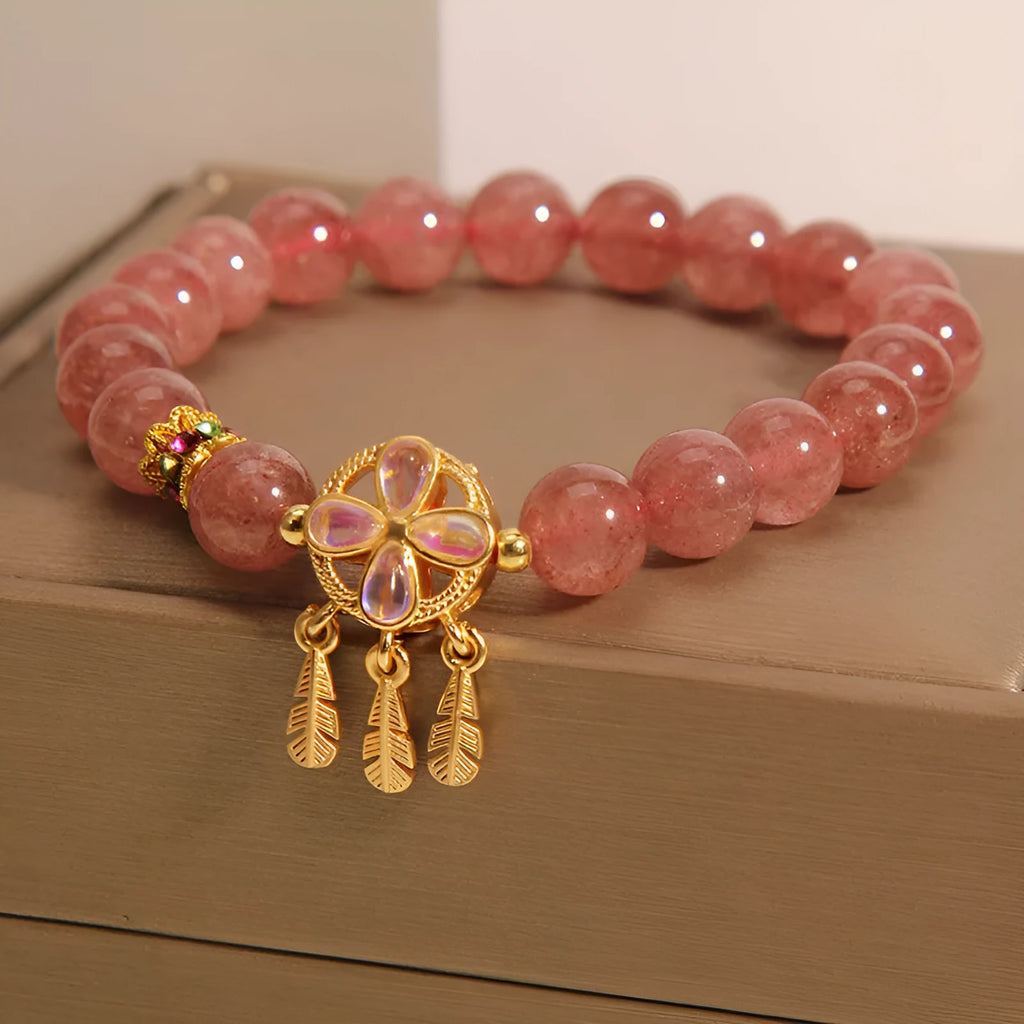 Women's strawberry quartz bracelet with four-leaf clover dream catcher ball pendant on adjustable leather cord