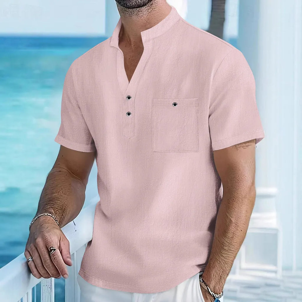 Man wearing a light-coloured linen stand collar t-shirt with short sleeves in a loose fit