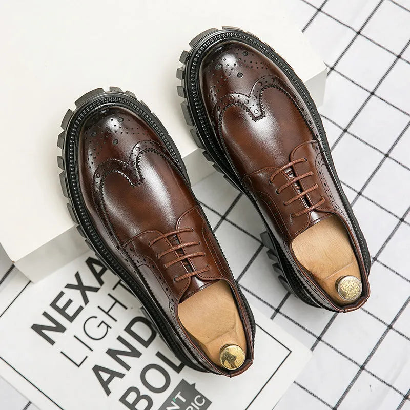 Men's black leather brogue shoes with round toe design on solid background
