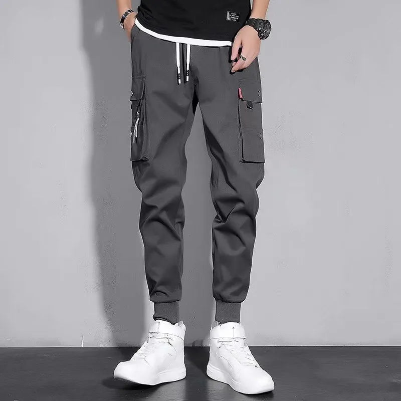 Men's cotton-polyester sports overalls in black with embossed finish and printed details, side view