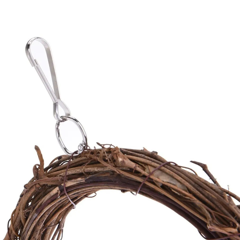 Natural rattan parrot swing measuring 26x16cm in brown, attached to cage bars
