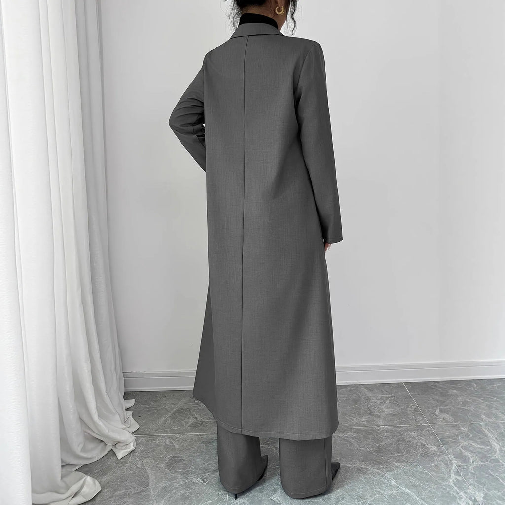 Women's gray polyester two-piece suit with long jacket and trousers on mannequin