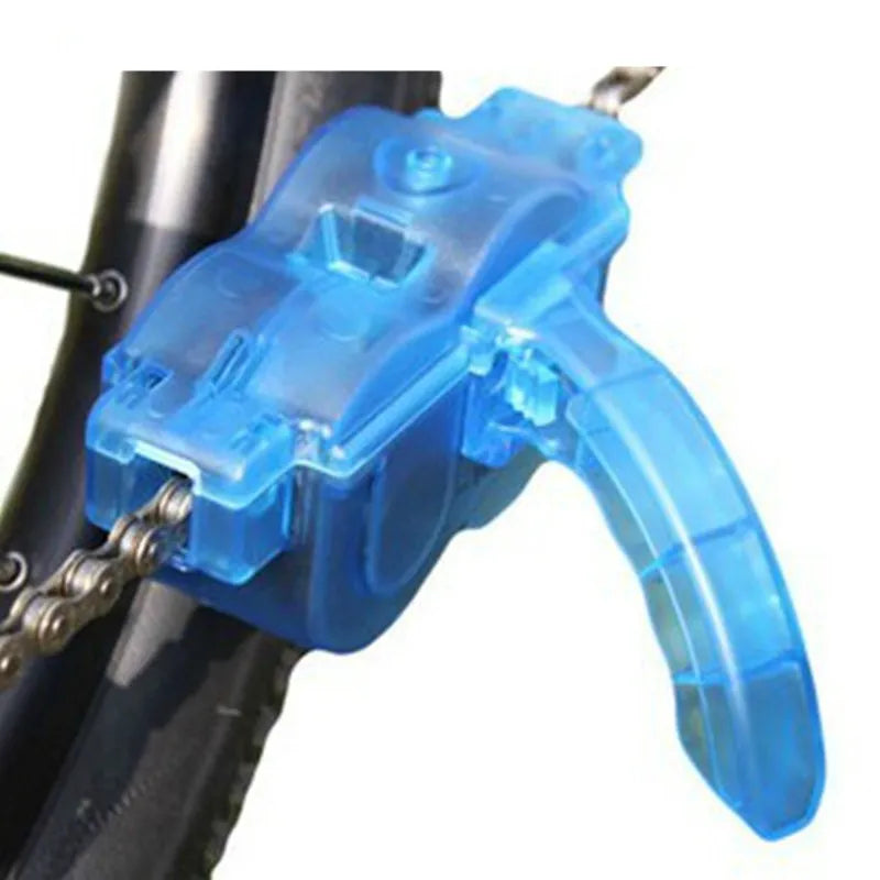 Blue plastic bicycle chain cleaning washer set with brushes on a bike chain