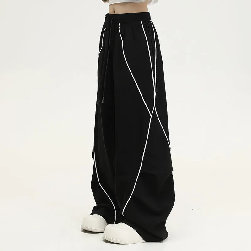 Black pleated hip hop trousers with wide-leg design and striped pattern