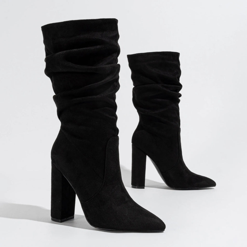 Women's black suede chunky heel boots with pointed toe and mid calf length.