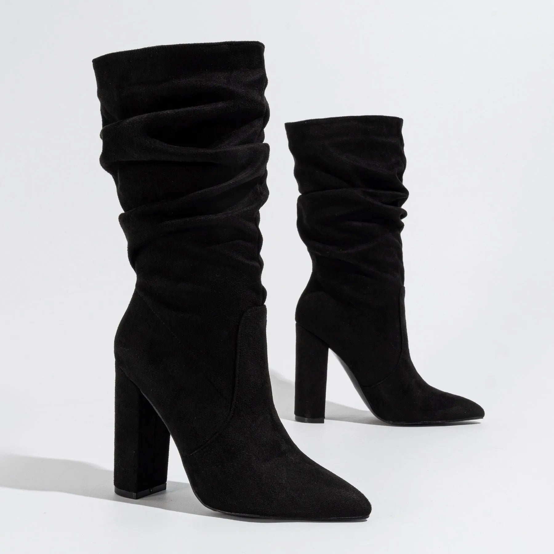 Women's black suede chunky heel boots with pointed toe and mid calf length.