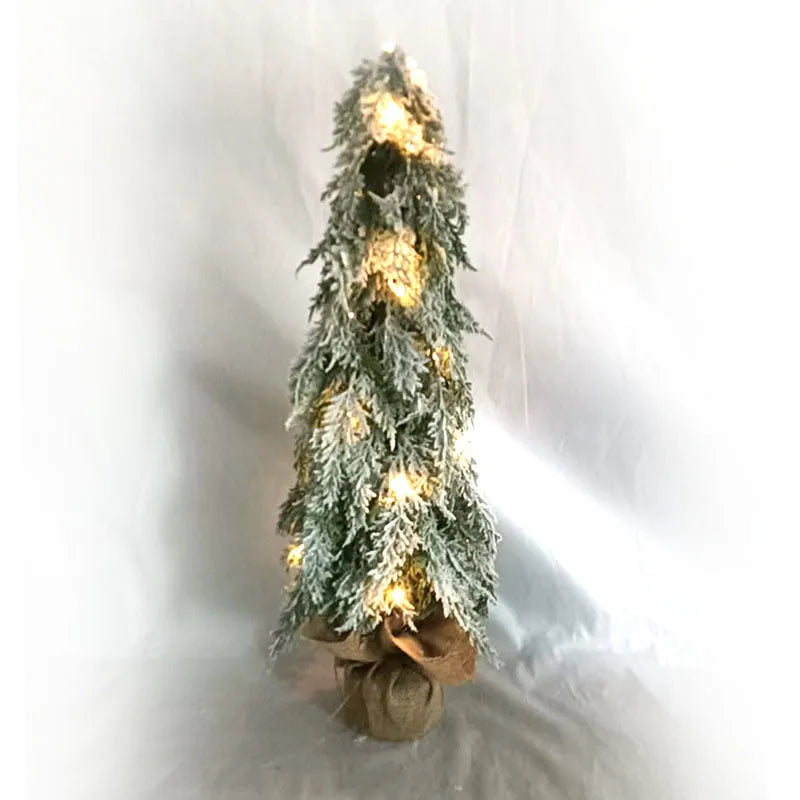 Small 24 inch white Christmas tree with built-in lights and simulated snow sprayer effect on branches