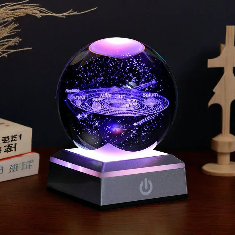 Transparent white crystal ball night light with 3D inner carving of Milky Way on black square colourful base