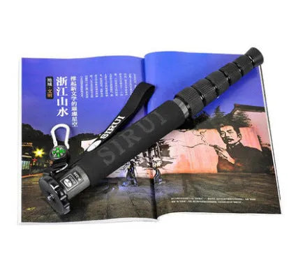Black carbon fibre monopod for DSLR cameras extended to maximum height