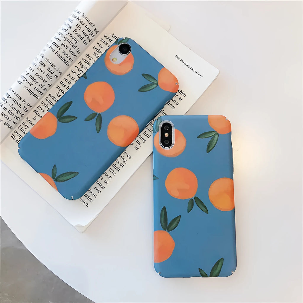 Orange retro plastic iPhone case with water and blue background design on a table.